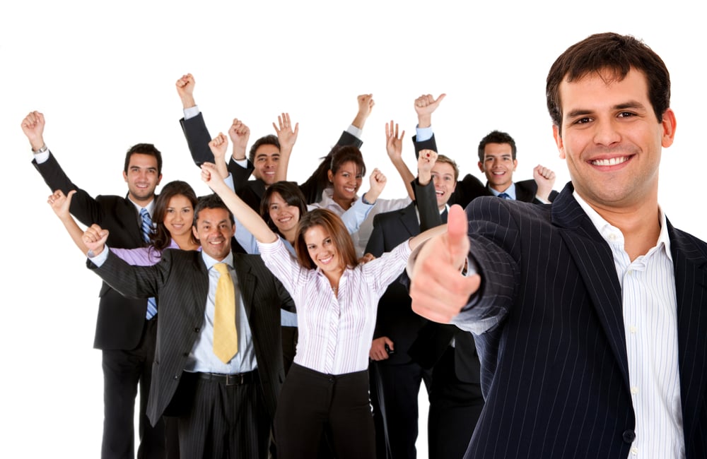 Business man leading a successful corporate group with thumbs up ? isolated